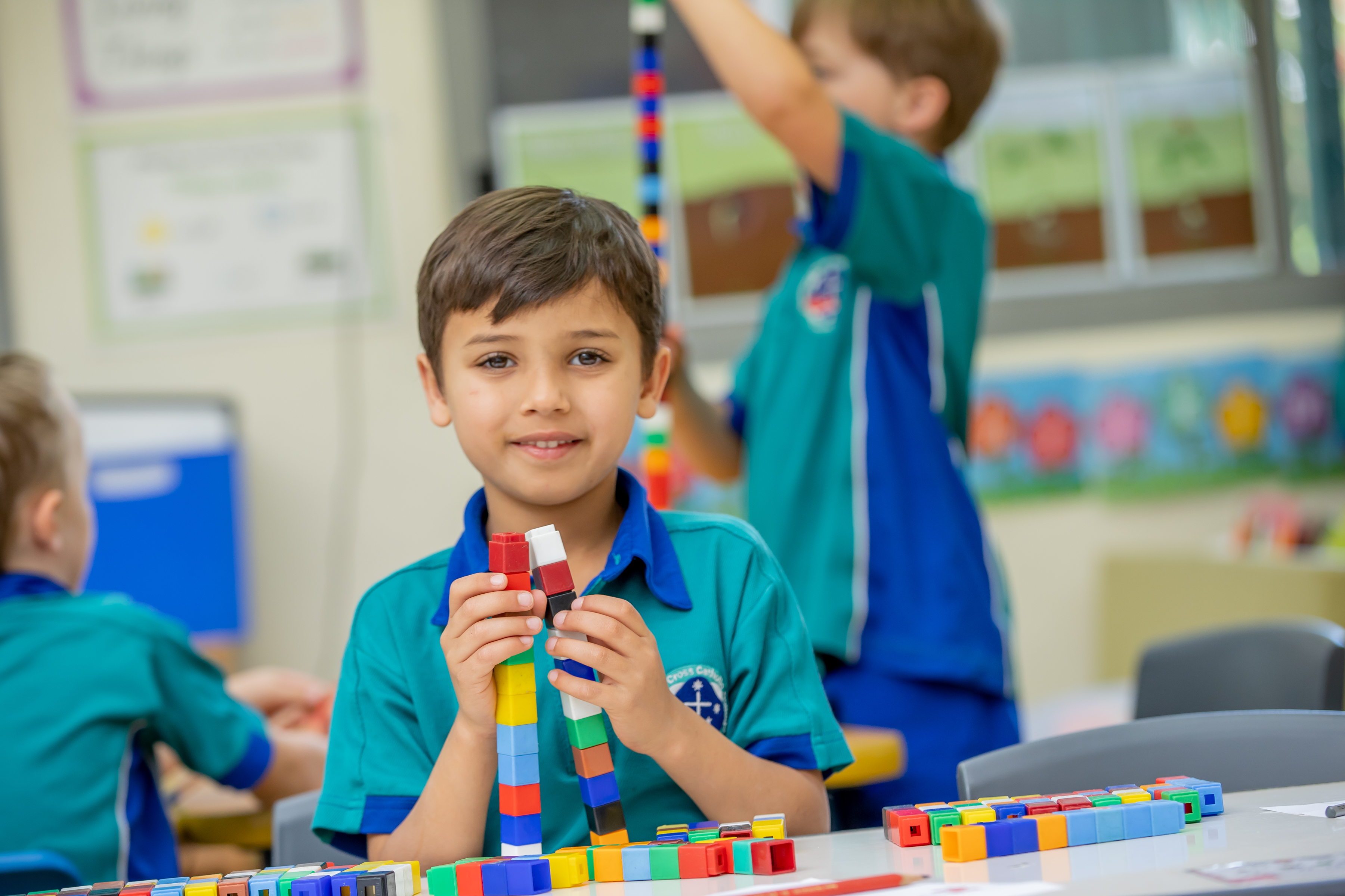 young student playing with blocks